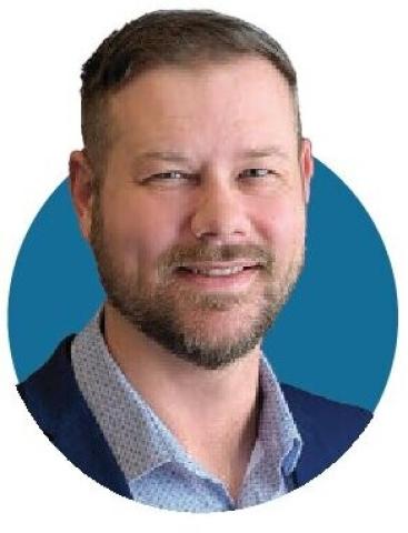 Portrait of Kyle Jaracz in front of a blue circular background
