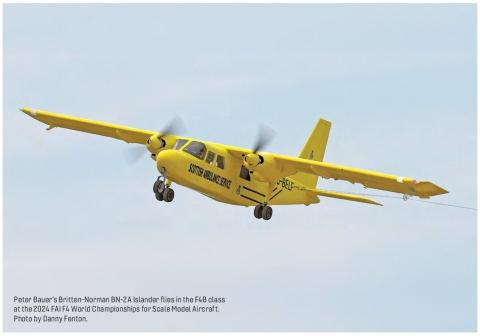 Yellow Britten-Norman BN-2A Islander model flying in competition.