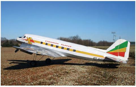 Model DC-3 painted in Ethiopian Airlines livery on a grass runway