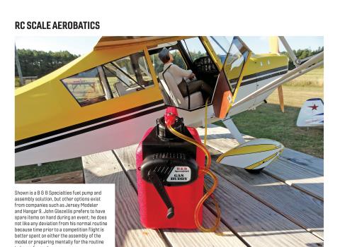 Red fuel pump and a yellow-and-white RC scale airplane on a wooden picnic table.