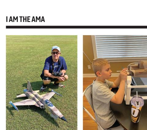 Man kneeling on grass beside a model Northrup F-5 jet holding a radio transmitter