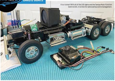 Completed 1/14-scale Tamiya semi model with exposed wiring and electronic components