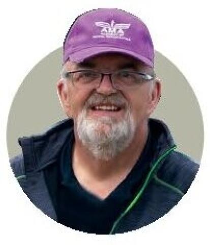 Portrait of Eric Williams wearing an AMA cap