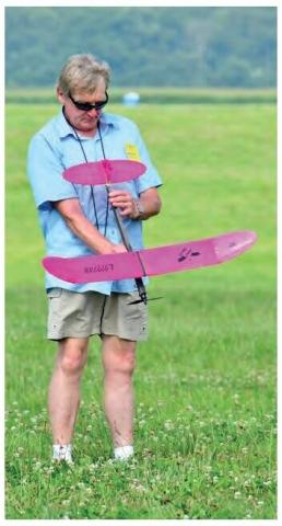 Mark Freeland holding a pink model airplane outdoors