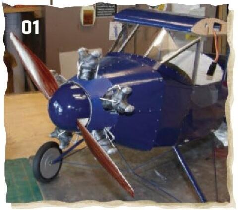 Blue model airplane displayed in a workshop