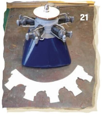 Radial engine dummy fitted to a blue cowling above a paper cutting pattern.