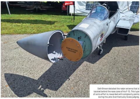 F-15 model jet with its nose cone removed to show the radar antenna behind it.