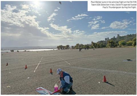 Paul Walker preparing a control line model aircraft on a flying field beside Folsom Lake.