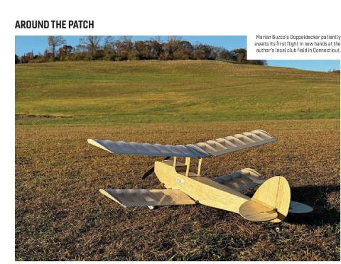 Wooden Doppeldecker biplane resting on a grass field