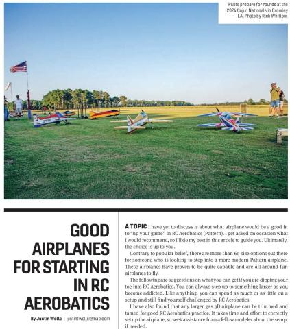 Radio-control aerobatic airplanes lined up on a grass flying field.