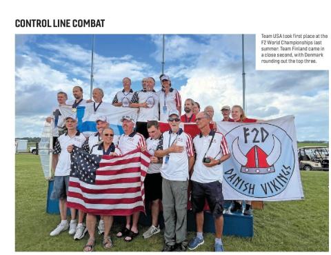 Team USA members holding an American flag beside the Danish Vikings banner at the F2 World Championships.